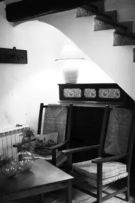 a dining room with two chairs and a table at El Celler de la Guàrdia in Montserrat