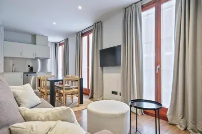 a living room with a couch and a table at Uma Suites Barceloneta Beach in Barcelona
