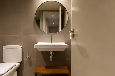 a bathroom with a sink and a mirror at Uma Suites Barceloneta Beach in Barcelona