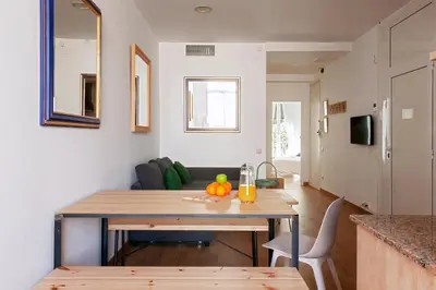 a living room with a table with fruit on it at My Address in Sant Antoni in Barcelona