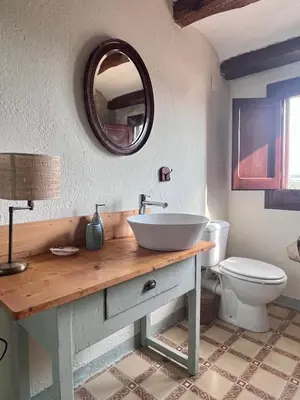 a bathroom with a sink and a toilet at Cal Muntanyès in Font-Rubí