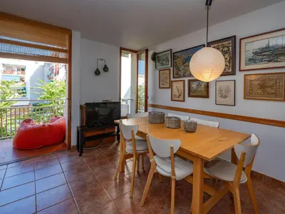 a dining room with a wooden table and chairs at Apartment Zodiak by Interhome in Pineda de Mar