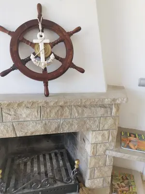 a rendering of a fireplace with a steering wheel and a chandelier at CAN TRULLEN CHALET CALAFELL in Calafell