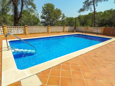 a swimming pool in a backyard with a fence at Simba Apartment by Hello Homes Sitges in Sitges