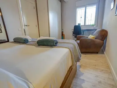 a bedroom with a bed with two pillows on it at Simba Apartment by Hello Homes Sitges in Sitges