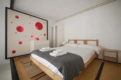 a bedroom with a bed with two towels on it at Catalunya Casas Pied-à-terre in central Barcelona 100m from beach in Barcelona