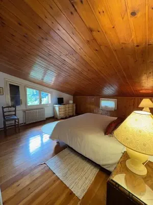 a bedroom with a bed in a wooden ceiling at Hostal l´Ou de Reig in Montseny