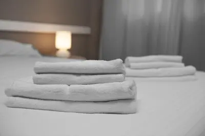 a group of white towels stacked on a bed at Bcn Sagrada Familia Apartments in Barcelona