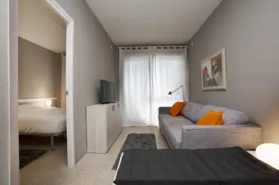 a small living room with a couch and a television at Bcn Sagrada Familia Apartments in Barcelona