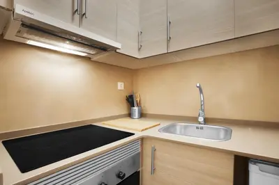 a small kitchen with a sink and a counter at Bcn Sagrada Familia Apartments in Barcelona