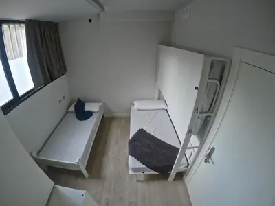 a small room with a bunk bed and a ladder at Room018BCN in Barcelona