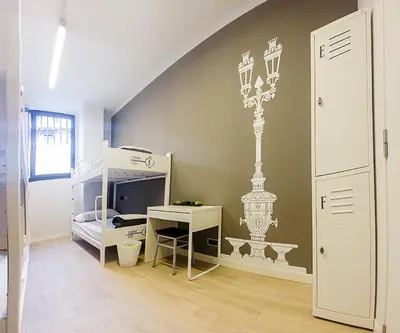 a room with a bedroom with a bed and a desk at Room018BCN in Barcelona