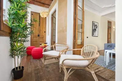 a living room with two chairs and a table at The Collection Barcelona - Paseo St Joan classic 4BD for 10 guests in Barcelona