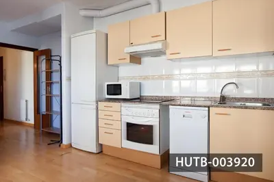 a kitchen with white cabinets and a white stove top oven at Splash in Barcelona