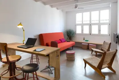 a living room with a table and a couch at Best House Best Place in Barcelona
