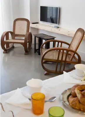 a table with a plate of bread and a tv at Best House Best Place in Barcelona
