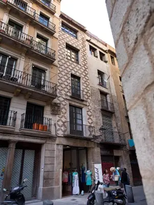 a building with clothes on display in front of it at Best House Best Place in Barcelona