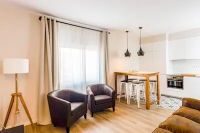 a living room with a couch and chairs and a table at MadreMia - Chic Hub Barcelona in Hospitalet de Llobregat