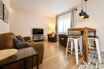 a living room with a couch and a table at MadreMia - Chic Hub Barcelona in Hospitalet de Llobregat