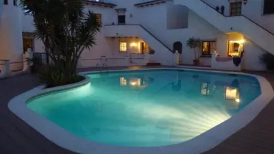 a large swimming pool in a house at night at Tot Gaviota in Sitges