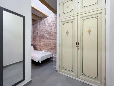 a room with white cabinets and a bed at Stay U-nique Apartment Comte Urgell II in Barcelona