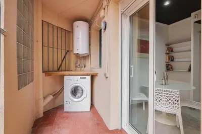 a washer and dryer in a hallway of a house at Stay U-nique Apartment Comte Urgell II in Barcelona