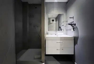 a bathroom with a white sink and a shower at Stay U-nique Apartment Comte Urgell II in Barcelona
