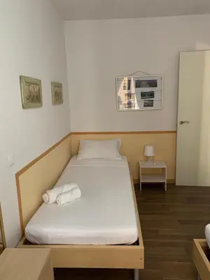a bedroom with a bed and a table with a night stand at Apartament modern al carrer Blai, Poble Sec in Barcelona