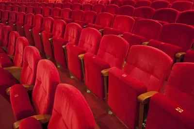an auditorium with red seats in a theatre at Apartament modern al carrer Blai, Poble Sec in Barcelona