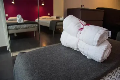 a pile of towels sitting on top of a couch at Villa Sagrada in Barcelona