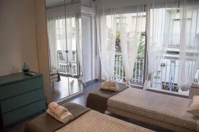 a bedroom with two twin beds and a balcony at Villa Sagrada in Barcelona