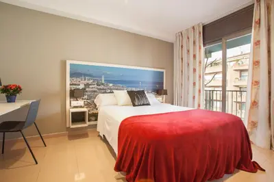 a bedroom with a large bed and a window at Rosselló Apartment in Barcelona