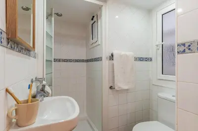 a bathroom with a sink and a toilet at Canela Homes BARCELONA SANT ANTONI in Barcelona