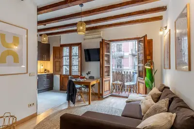 a living room with a couch and a table at Canela Homes BARCELONA SANT ANTONI in Barcelona