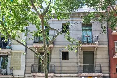 an apartment building with balconies and a tree at BBarcelona Sagrada Familia Terrace Flat in Barcelona