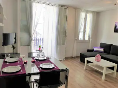 a living room with a table and a couch at Sitges Center & Beach with Sea View in Sitges
