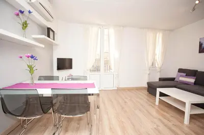 a living room with a table and a couch at Sitges Center & Beach with Sea View in Sitges