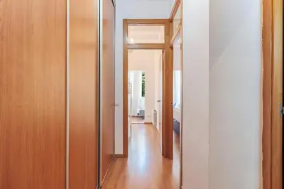 a hallway leading to a room with a mirror at Bright 2BR in Clot Desk Fiber Wi-Fi in Barcelona