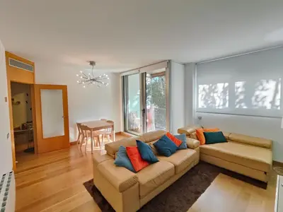 a living room with a couch and a table at Family apartment Forum in Sant Adria de Besos