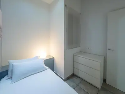 a bedroom with a white bed with a lamp on it at Stay U-nique Apartments Nació in Barcelona