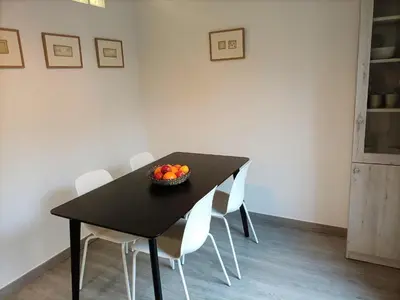 a black dining room table with white chairs and a bowl of fruit at Suitur apartamento floridablanca barcelona in Barcelona
