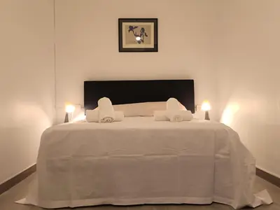 a white bed with two lights on top of it at Suitur apartamento floridablanca barcelona in Barcelona