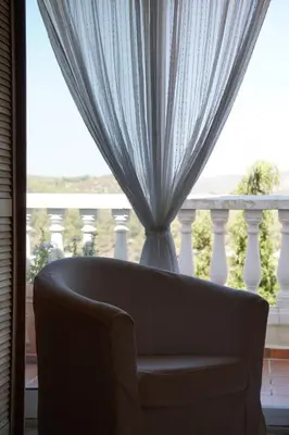 a bed with blue and white pillows on it at Habitación Atalaya in Olivella