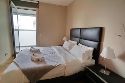 a bedroom with a large bed with towels on it at Fira Gran Via - Barcelona4Seasons in Hospitalet de Llobregat