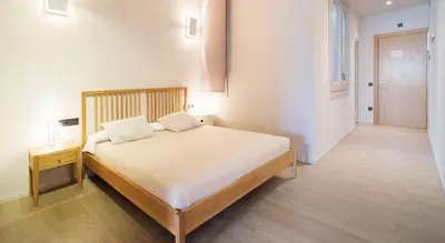 a bedroom with a large bed and a wooden floor at Barcelona InLoft in Barcelona