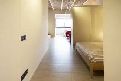 a room with a bed and a hallway at Barcelona InLoft in Barcelona