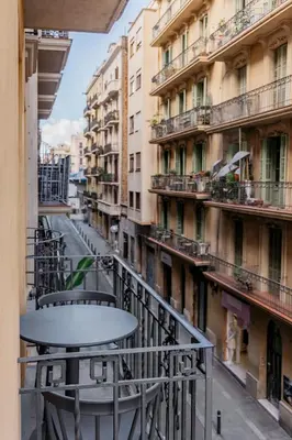 a balcony with two tables and a view of a city at Barcelona Apartment Milà in Barcelona