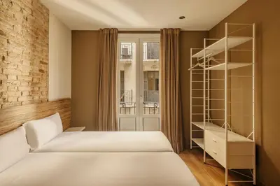 a bedroom with a bed and a book shelf at Barcelona Apartment Milà in Barcelona