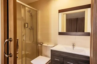 a bathroom with a toilet sink and a shower at Barcelona Apartment Milà in Barcelona