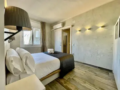 a hotel room with a bed and a chair at BarcelonaForRent Market Penthouse in Barcelona